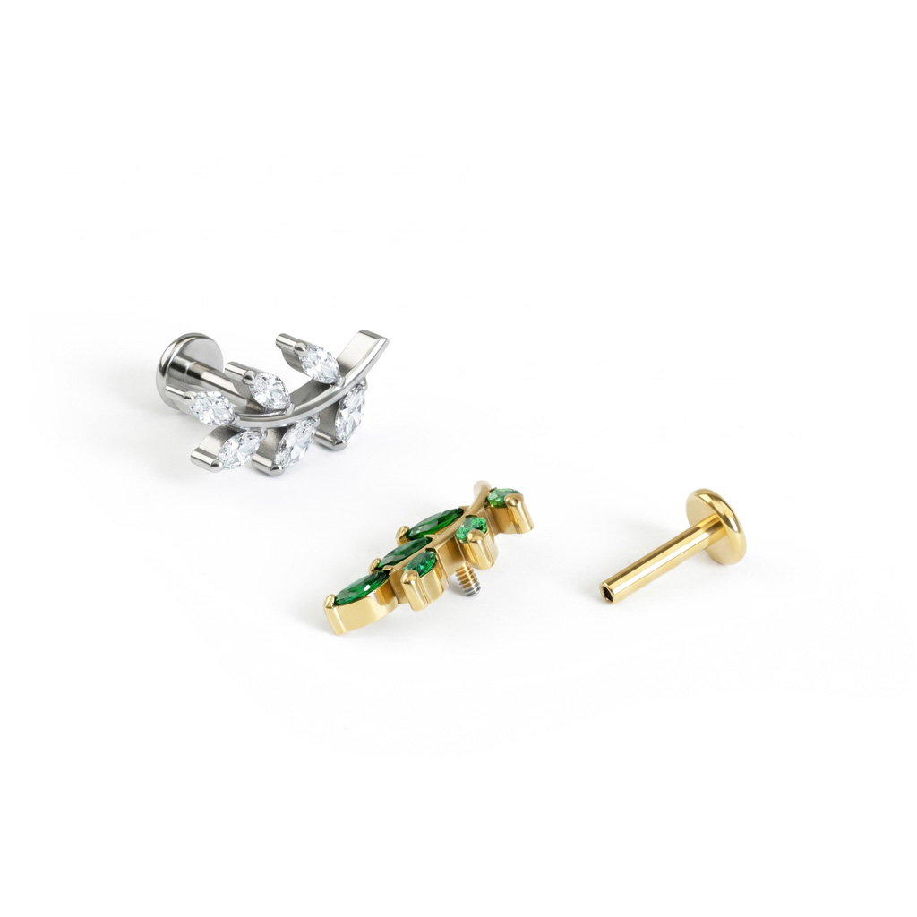 Labret i form av blad med stener