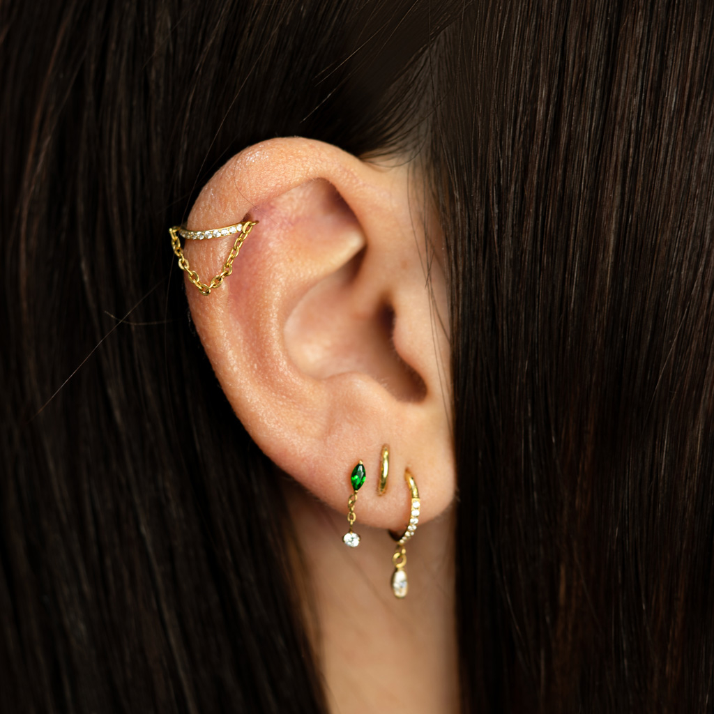 Titanlabret med smaradgrønn sten og anheng med detlalj