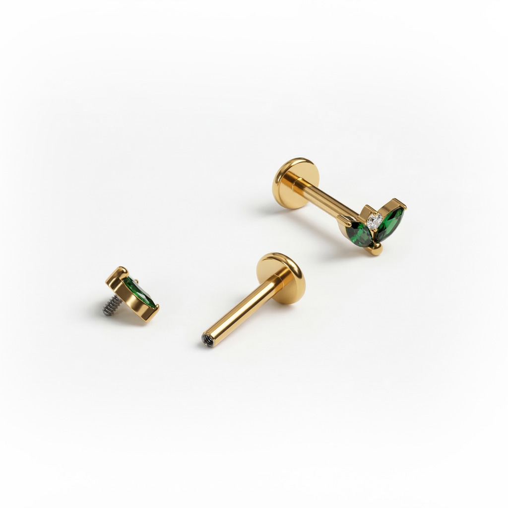 Titanlabret med par av smaragdfargede stener